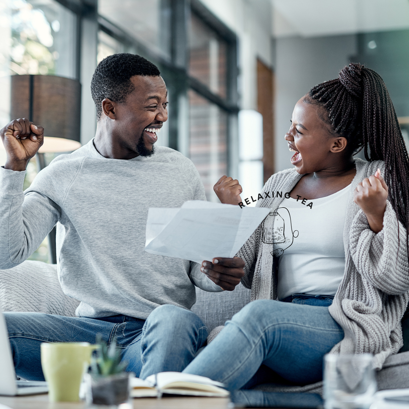 A couple celebrating good news while reviewing a document at home